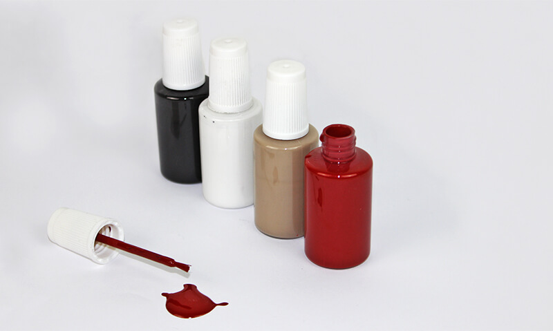 Bild på små burkar med olika färger som skickas med vid beställning.